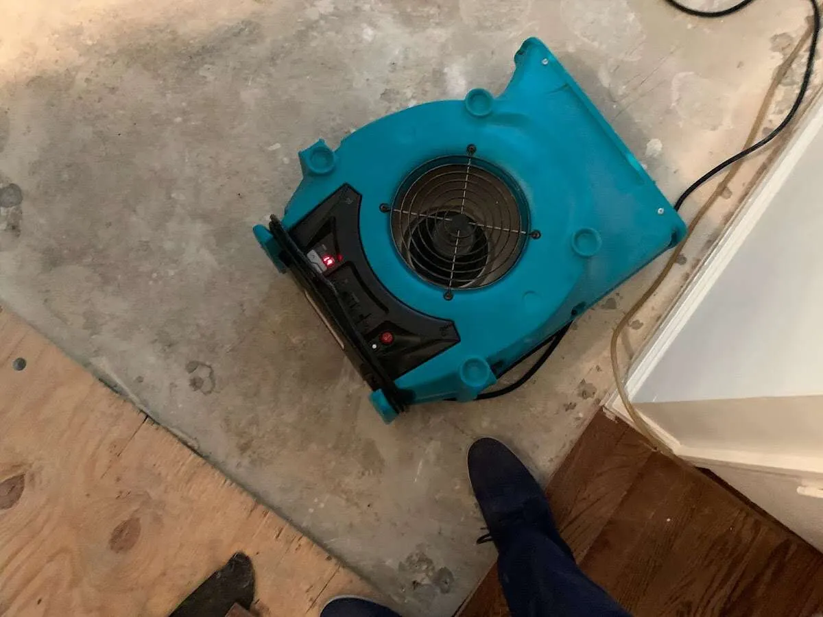Air mover drying subfloor during Commercial Water Damage Restoration in Rantoul